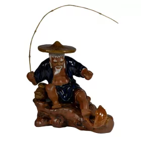 Ceramic Figure Sitting Fisherman While Fighting a Fish